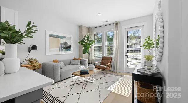 a living room with furniture and a potted plant