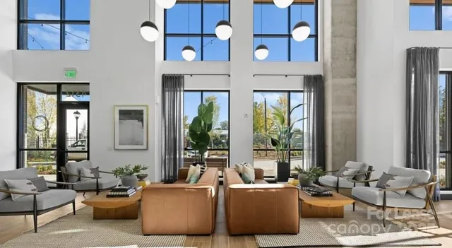 a living room with furniture and large windows