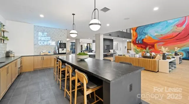 a large kitchen with lots of counter space and a chandelier
