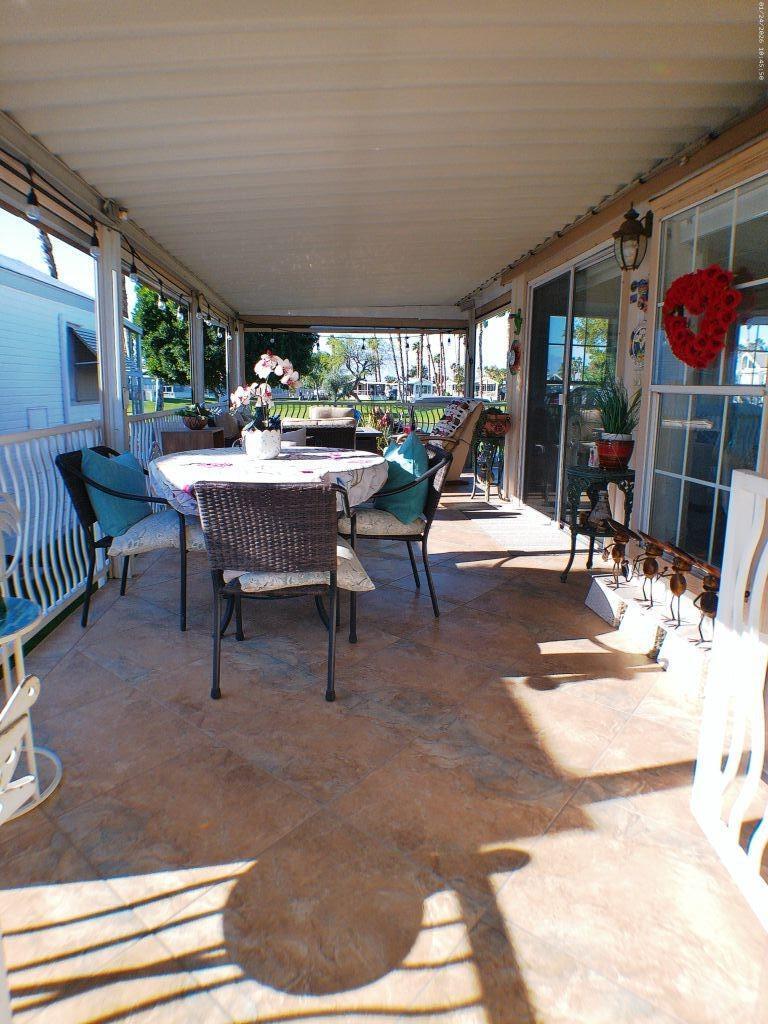 84136 Ave 44, Unit 262 Indio, CA 92203 - Photo 14 of 60 a view of a patio with a dining table and chairs