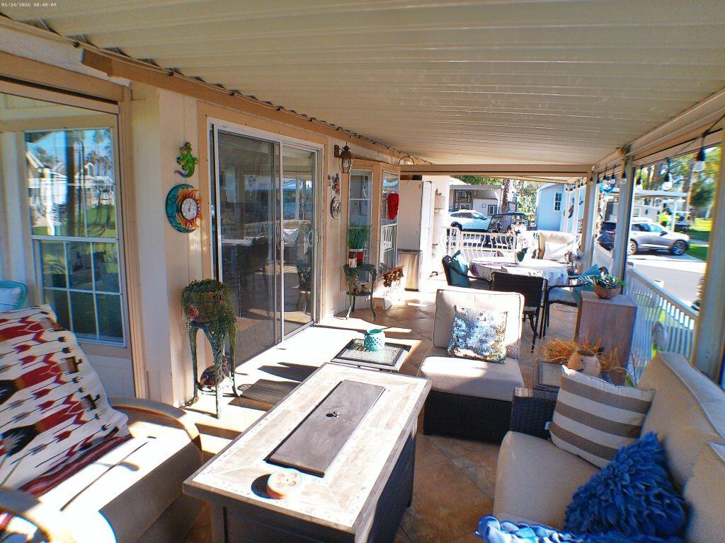 84136 Ave 44, Unit 262 Indio, CA 92203 - Photo 24 of 60 a living room with furniture and a floor to ceiling window