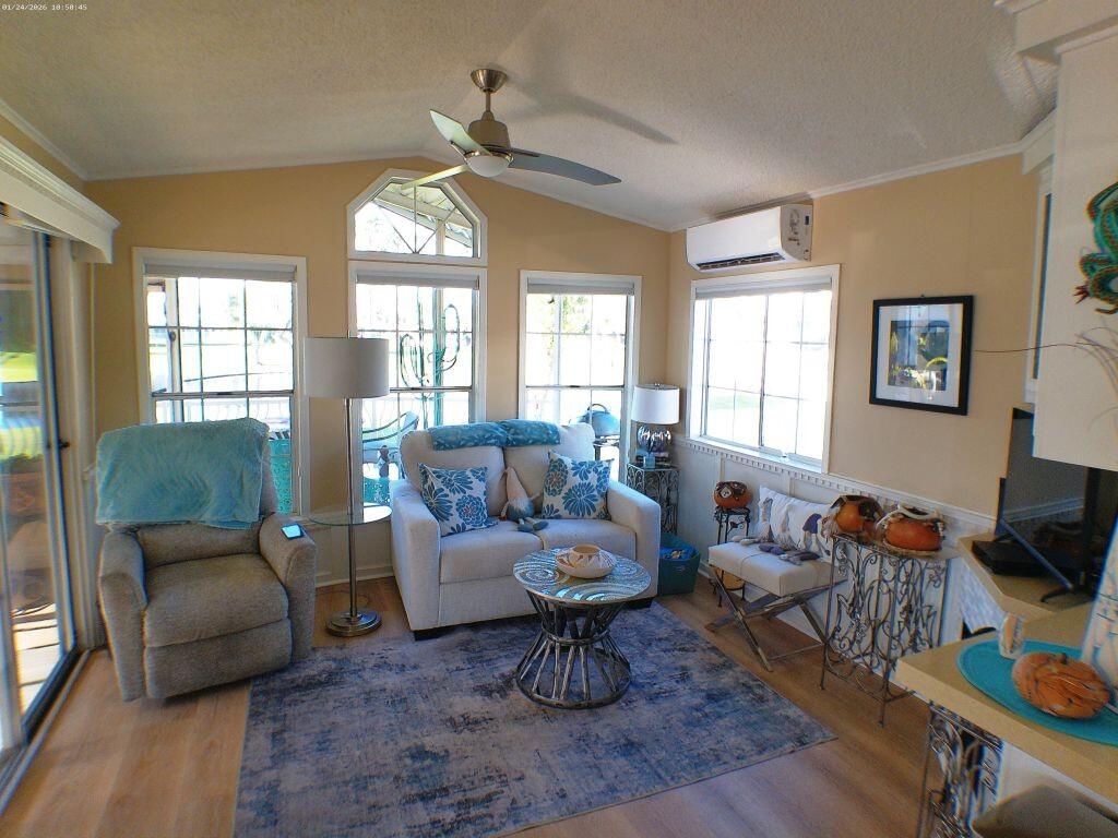 84136 Ave 44, Unit 262 Indio, CA 92203 - Photo 30 of 60 a living room with furniture a fireplace and a chandelier