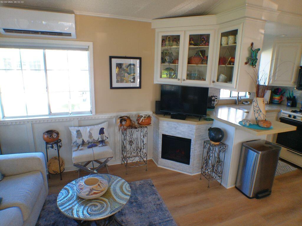 84136 Ave 44, Unit 262 Indio, CA 92203 - Photo 33 of 60 a living room with furniture a flat screen tv and a fireplace