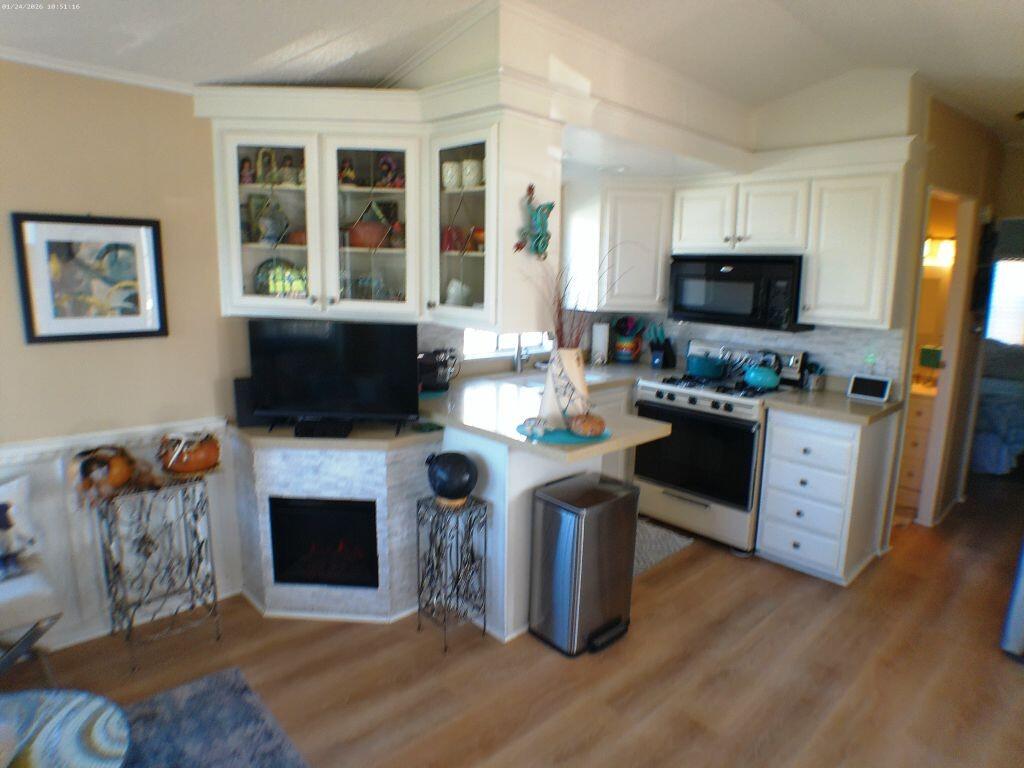84136 Ave 44, Unit 262 Indio, CA 92203 - Photo 34 of 60 a living room with furniture a flat screen tv and a fireplace