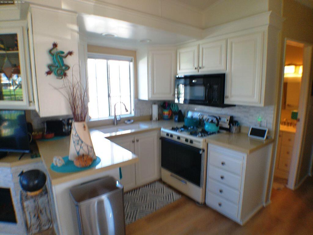 84136 Ave 44, Unit 262 Indio, CA 92203 - Photo 36 of 60 a kitchen with stainless steel appliances granite countertop a sink stove and refrigerator
