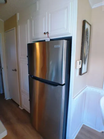 a kitchen with a sink a stove and a wooden cabinets
