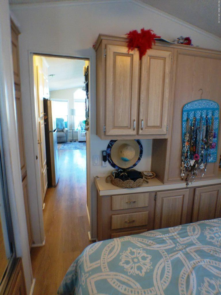 84136 Ave 44, Unit 262 Indio, CA 92203 - Photo 50 of 60 a kitchen with a sink a stove and a wooden cabinets