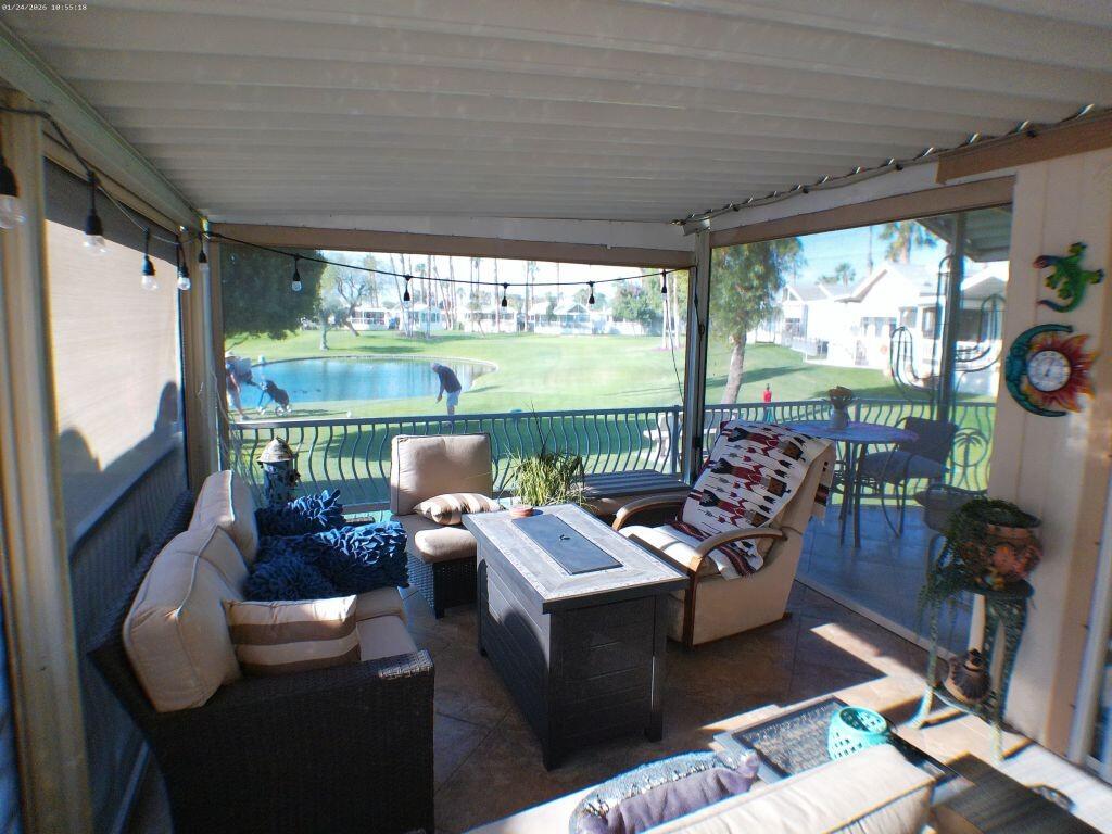 84136 Ave 44, Unit 262 Indio, CA 92203 - Photo 55 of 60 a living room with patio furniture and a floor to ceiling window