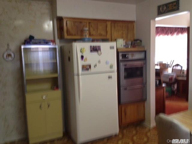 135-47 124th Street Queens, NY 11420 - Photo 13 of 17 a view of a kitchen from the hallway