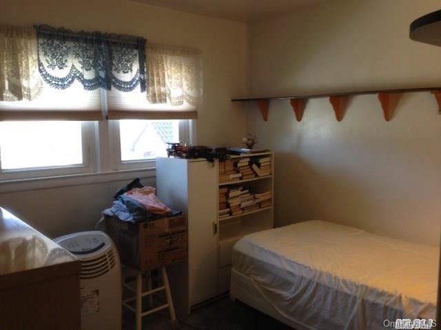 135-47 124th Street Queens, NY 11420 - Photo 16 of 17 a bedroom with a bed and a window