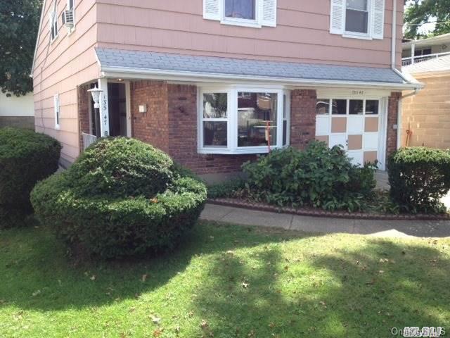 135-47 124th Street Queens, NY 11420 - Photo 5 of 17 a front view of a house with garden