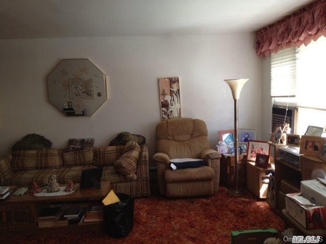 135-47 124th Street Queens, NY 11420 - Photo 7 of 17 a living room with furniture and a mirror
