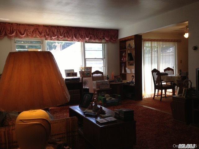 135-47 124th Street Queens, NY 11420 - Photo 9 of 17 a living room with furniture and a floor to ceiling window