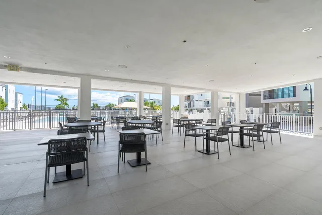 a kitchen with stainless steel appliances a refrigerator sink and white cabinets