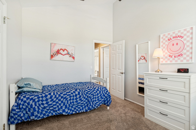 9832 Falconhurst Drive Sandy, UT 84092 - Photo 18 of 29 Vaulted ceiling room with light gray walls and plush carpet flooring