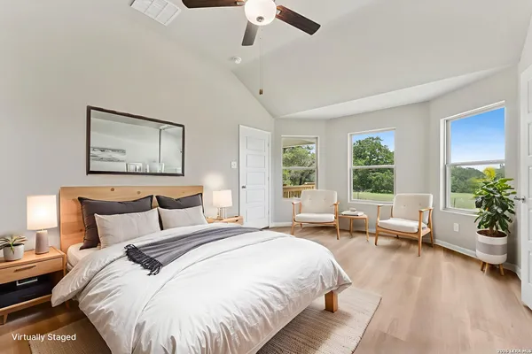 a spacious bedroom with a bed and a couch