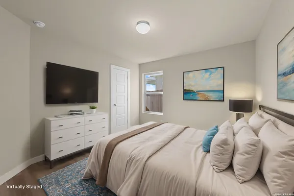a bedroom with a bed and a flat screen tv