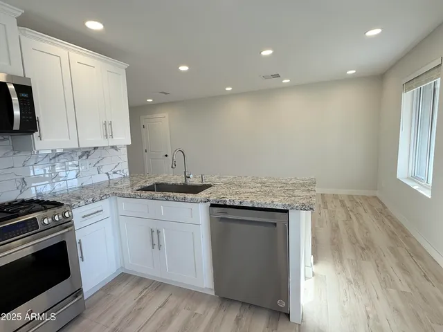 a kitchen with a sink stove and cabinets