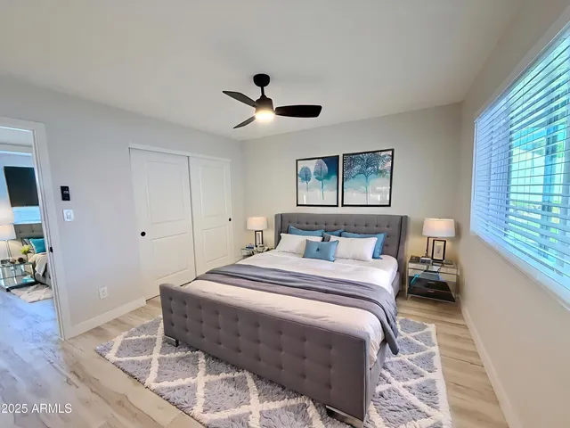 a bedroom with a bed and a chandelier