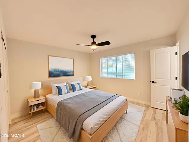 a bedroom with a bed and a potted plant