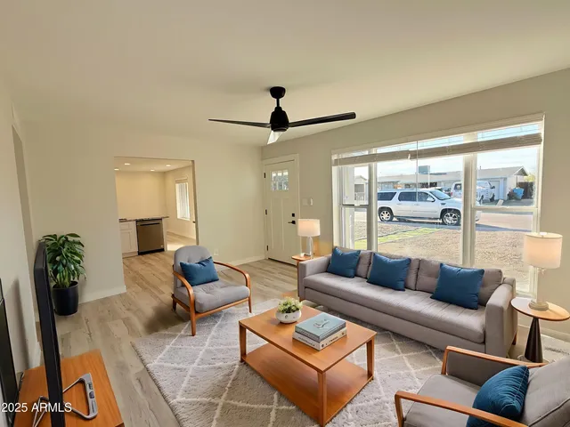 a living room with furniture and a large window