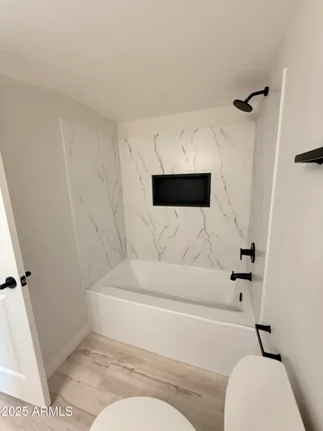 a bathroom with a toilet and a shower