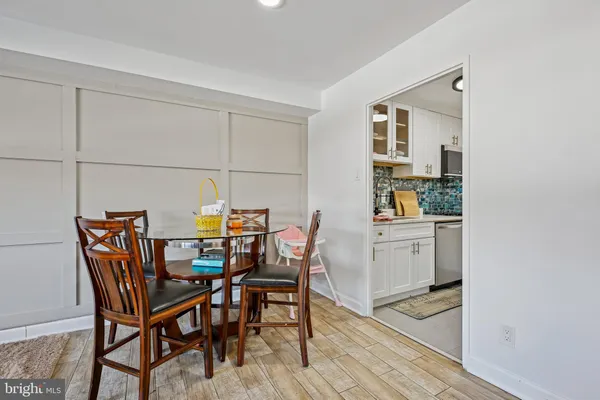 a living room with furniture and a dining table with rug floor