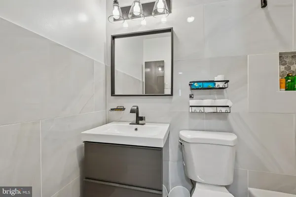 a bathroom with a shower a toilet and a sink