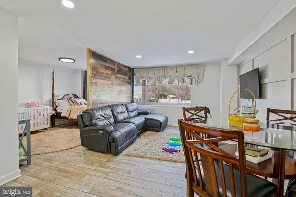 a dining room with furniture and wooden floor