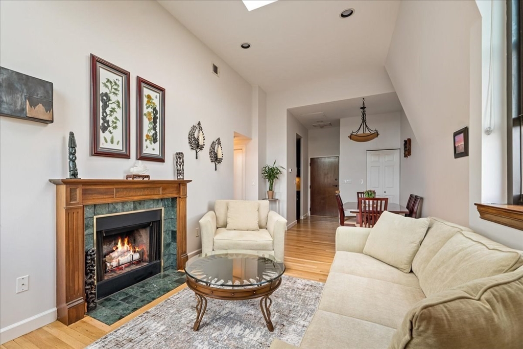 130 Appleton Street, Unit 4E Boston, MA 02116 - Photo 3 of 17 a living room with furniture a window and a fireplace