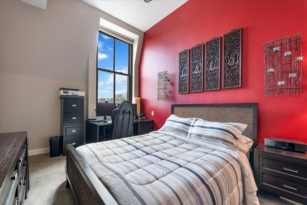 130 Appleton Street, Unit 4E Boston, MA 02116 - Photo 9 of 17 a bedroom with a bed and dresser with mirror