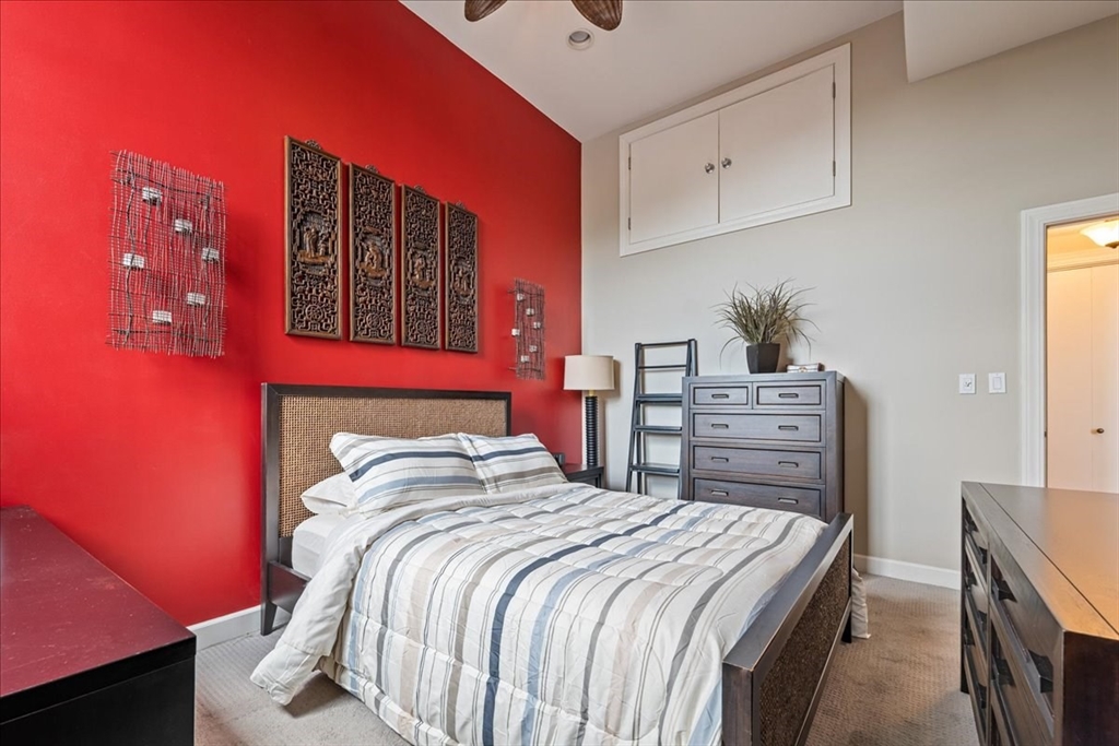 130 Appleton Street, Unit 4E Boston, MA 02116 - Photo 10 of 17 a bedroom with bed and paintings on the wall