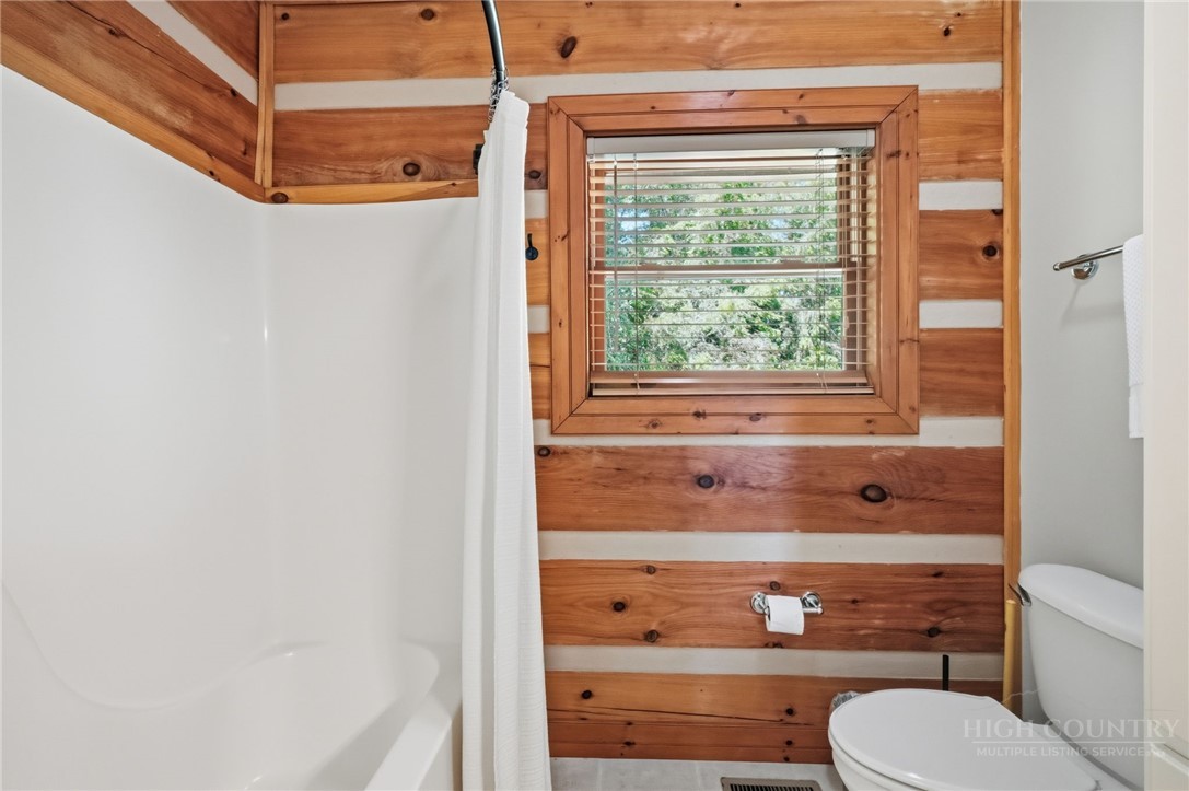 850 River Ridge Road Boone, NC 28607 - Photo 17 of 26 a bathroom with a bathtub and window