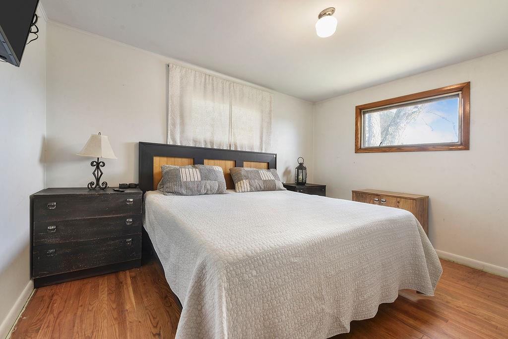 139 Camp Run Road Harmony, PA 16037 - Photo 21 of 41 a bedroom with a bed and wooden floor