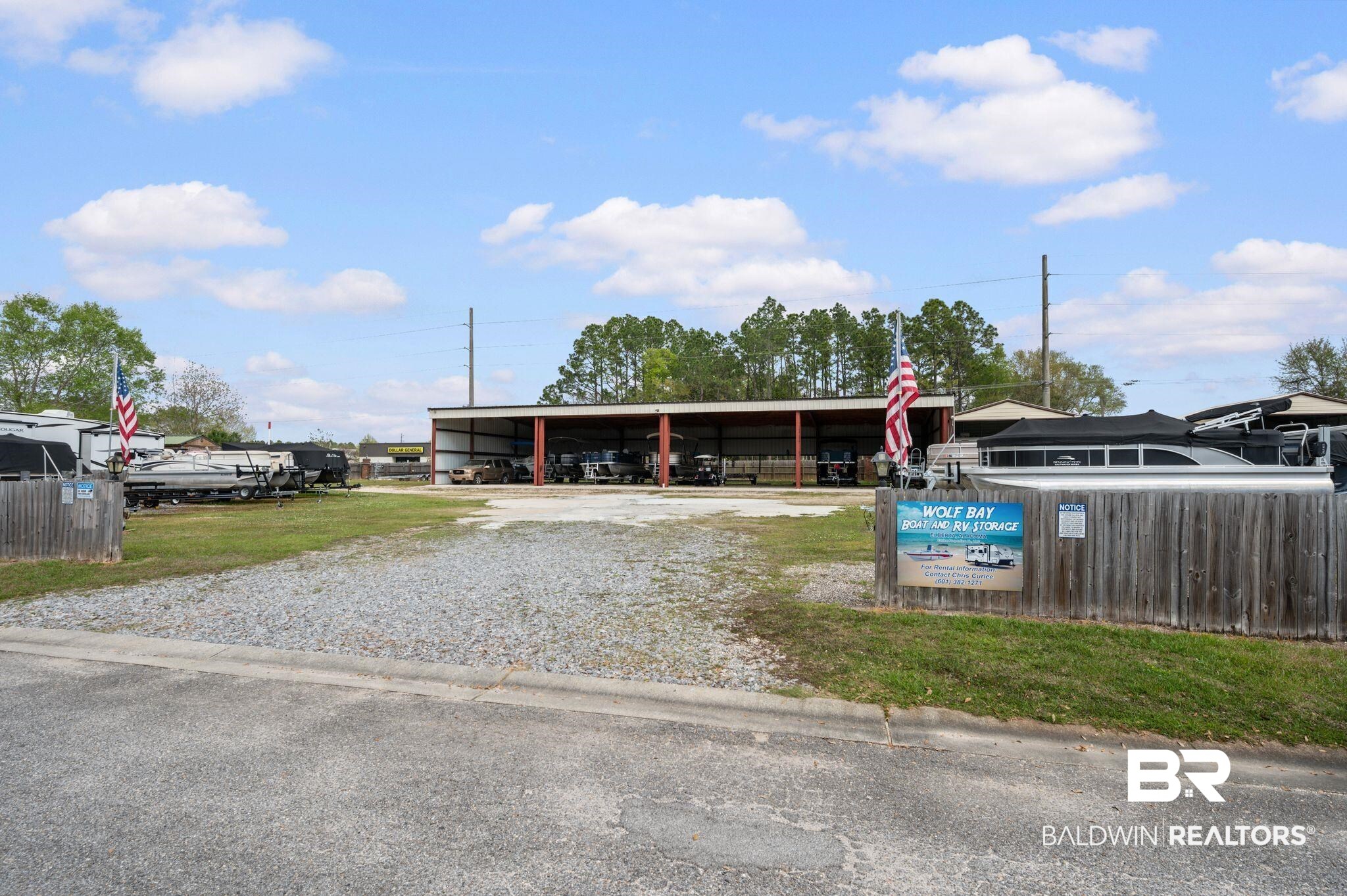 24711 County Road 20, Unit A11 Elberta, AL 36530 - Photo 32 of 35 View of building exterior with gravel driveway and a detached carport