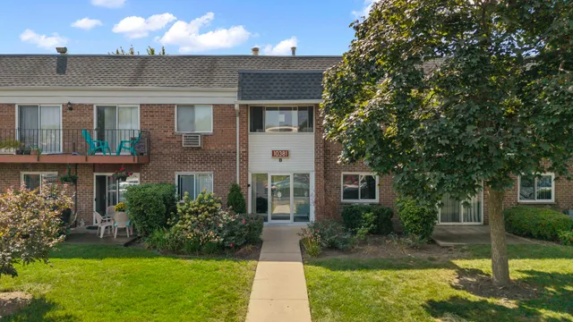 a front view of a house with a yard and porch