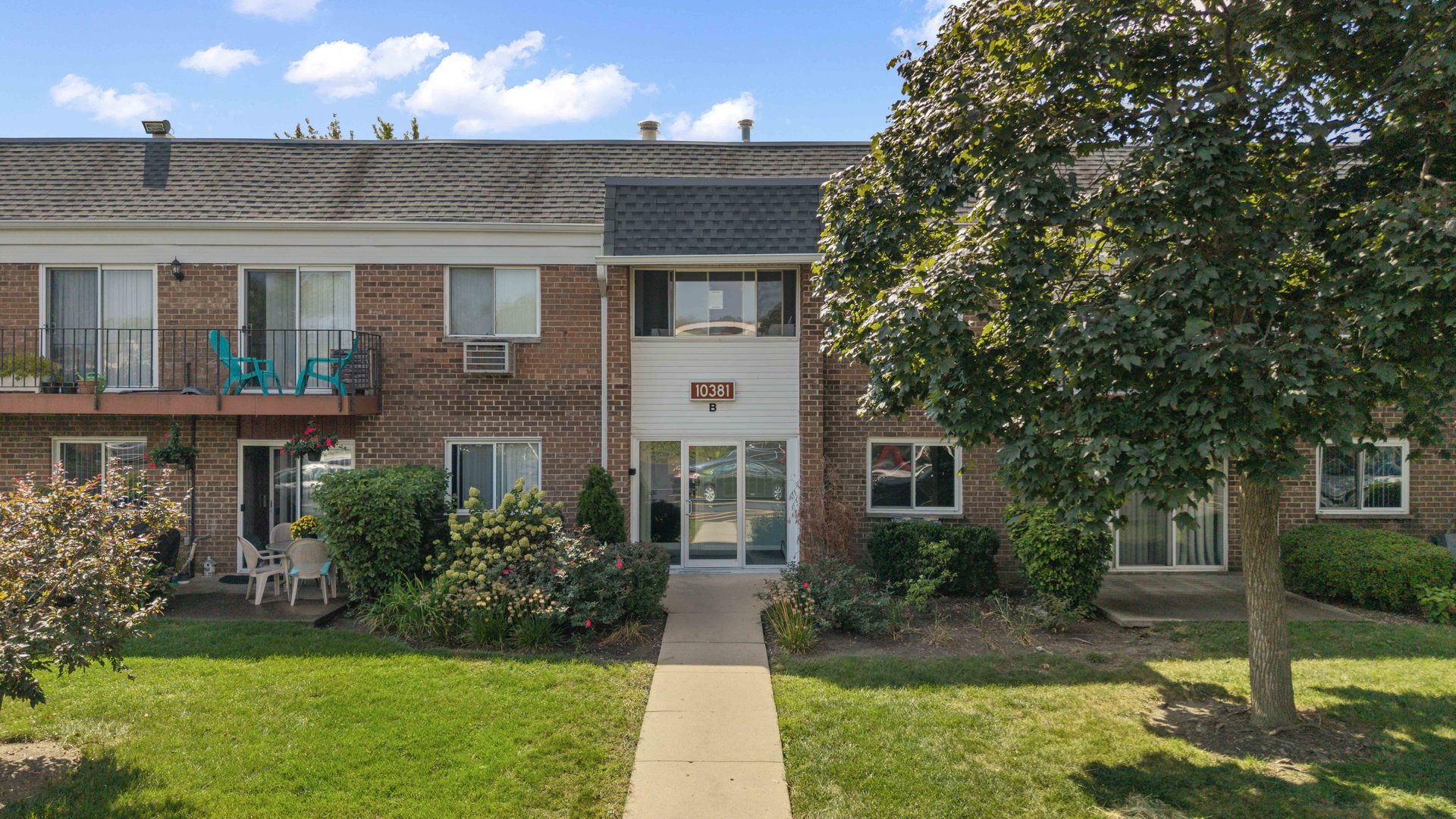 a front view of a house with a yard and porch