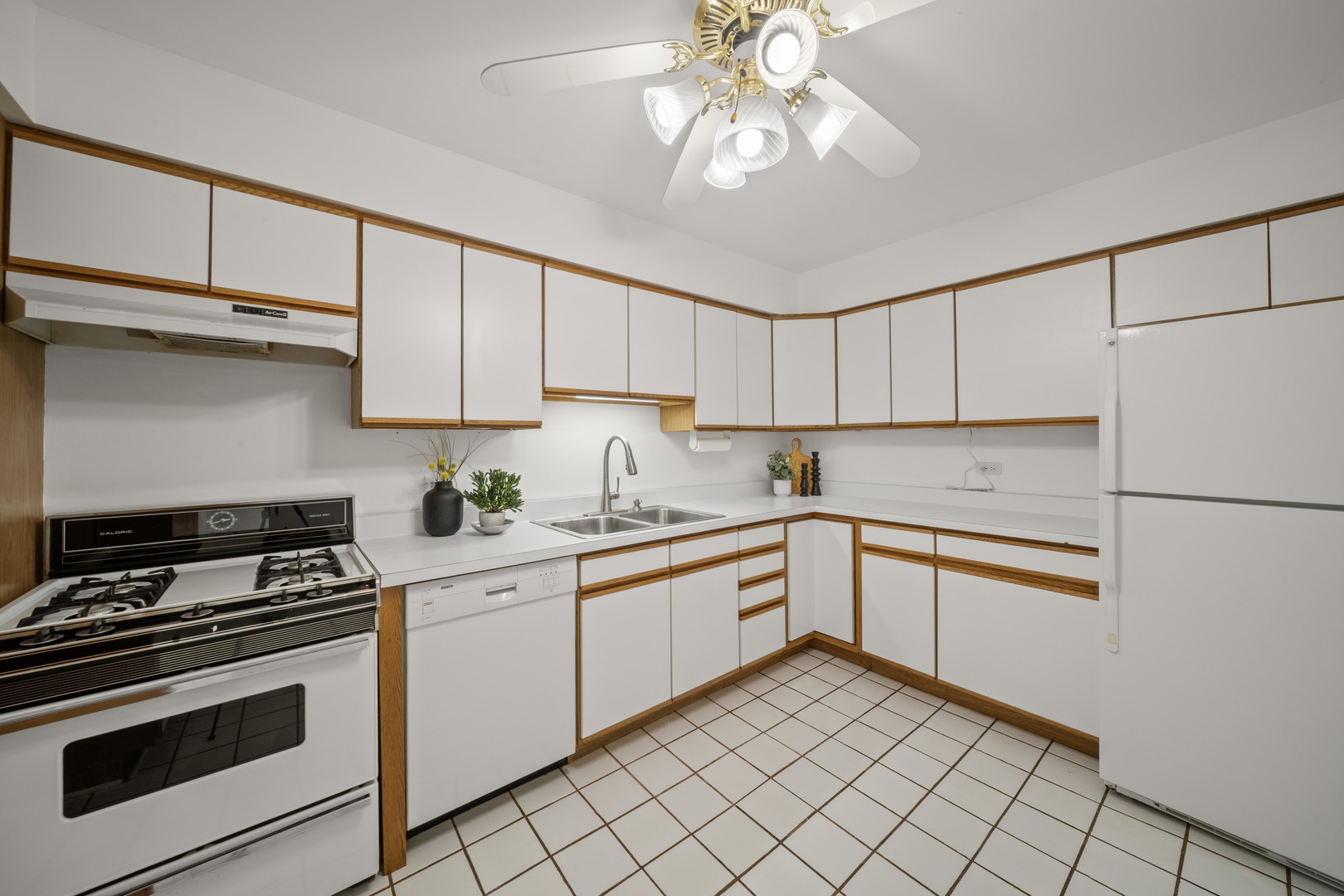 10381 Dearlove Road, Unit 2A Glenview, IL 60025 - Photo 7 of 19 a kitchen with granite countertop white cabinets and white appliances