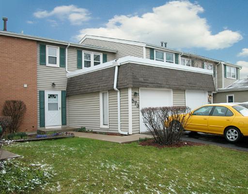 573 Thomas Road, Unit 573 Bolingbrook, IL 60440 - Photo 1 of 1 a front view of a house with a yard