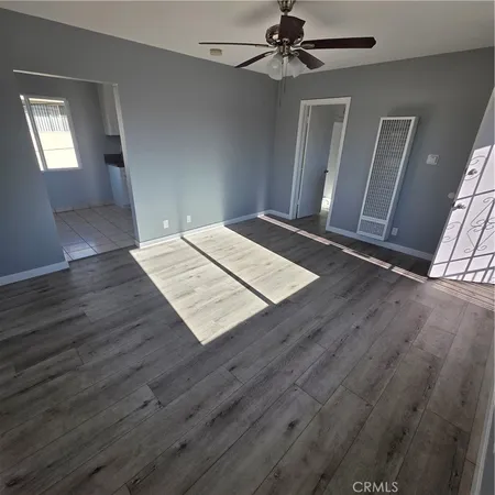 a view of an empty room and wooden floor