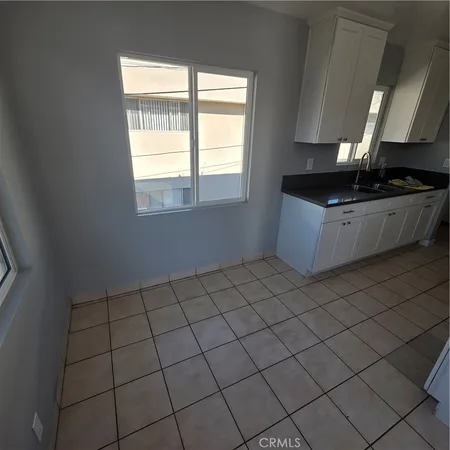 a kitchen with a sink cabinets and a window