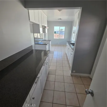 en empty room with wooden floor and windows