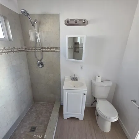 a bathroom with a toilet sink and shower