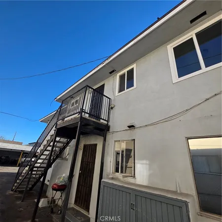a view of a house with iron stairs