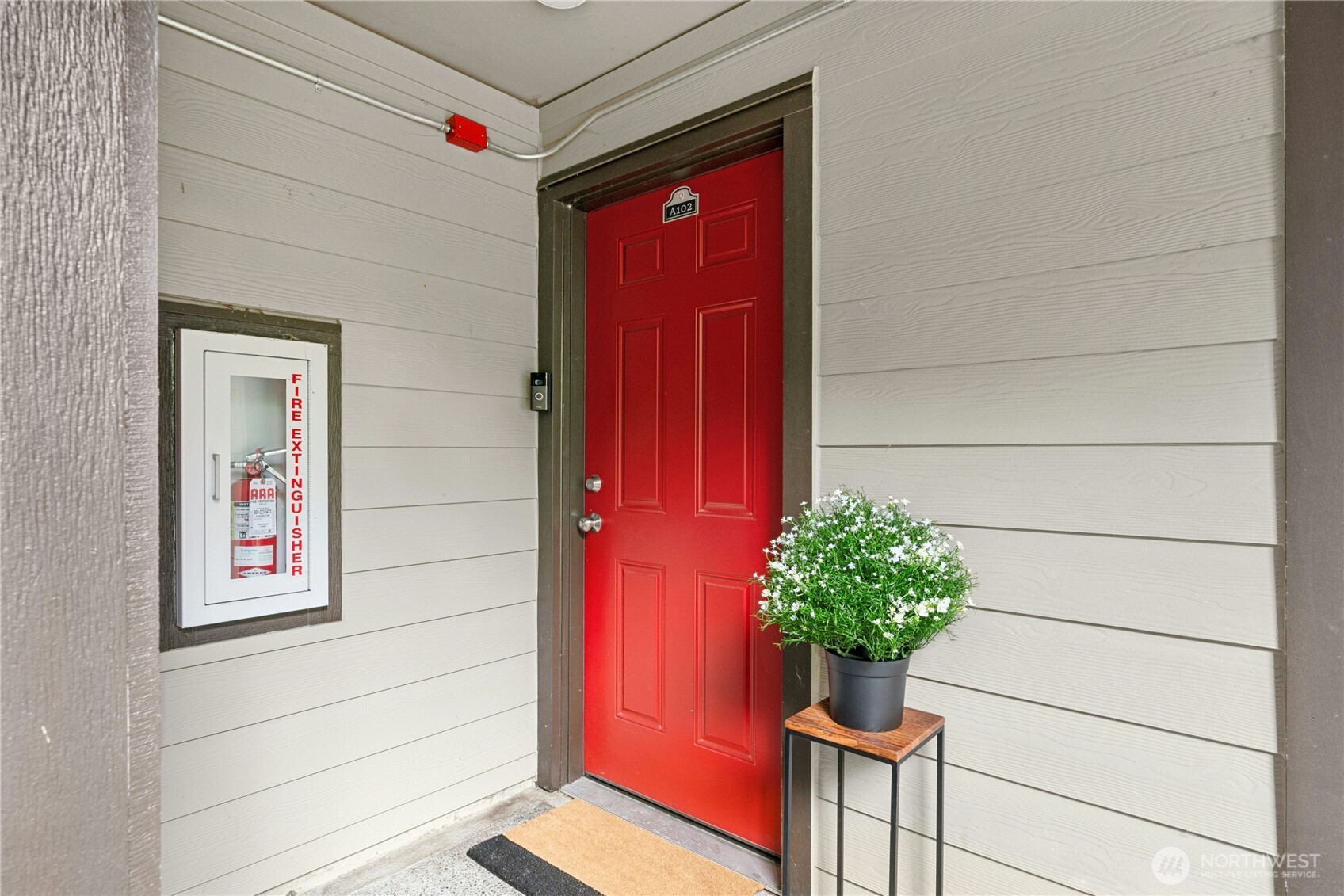 9523 Northeast 180th Street, Unit A102 Bothell, WA 98011 - Photo 2 of 29 a flower pot with a potted plant
