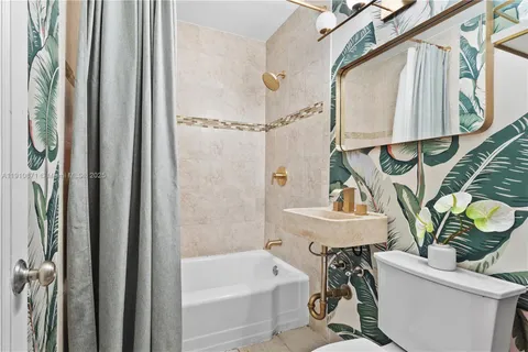 a bathroom with a sink a toilet and a bathtub