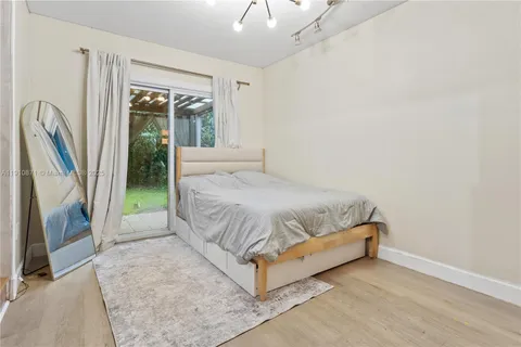 a large bed sitting in a bedroom next to a window
