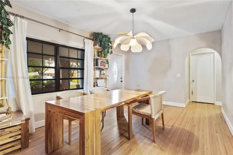 a view of a dining room with a table and chairs