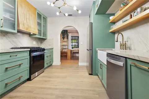 a kitchen with stainless steel appliances granite countertop a sink and cabinets