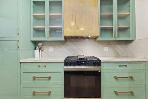 a kitchen with a stove and cabinets
